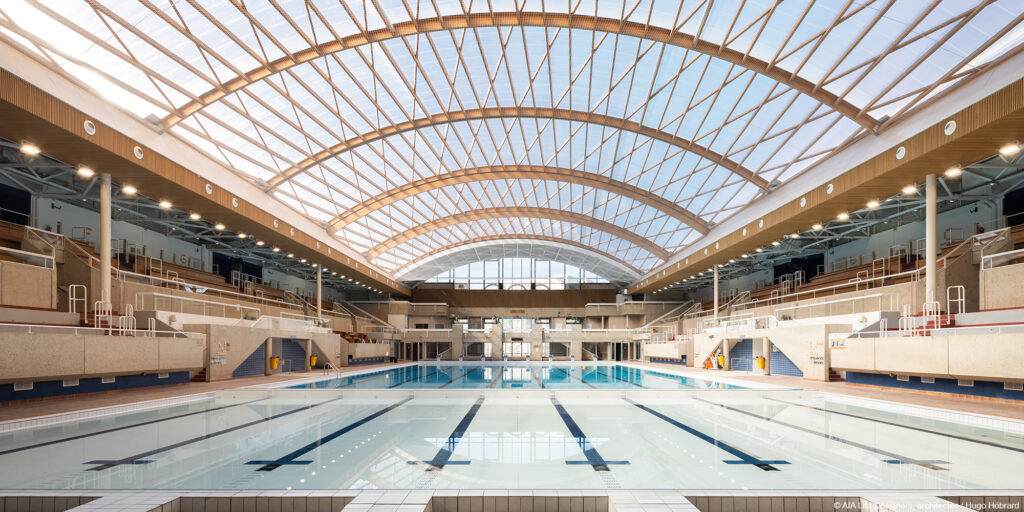 Rénovation piscine Georges Vallerey charpente mobile en bois lamellé collé